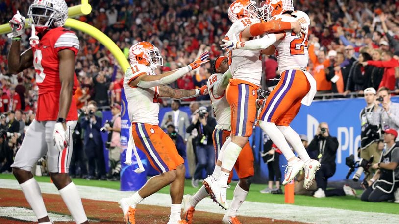 GLENDALE, ARIZONA - DECEMBER 28:  Nolan Turner #24 of the Clemson Tigers is congratulated by his teammates after intercepting the ball in the final minute of the second half against the Ohio State Buckeyes during the College Football Playoff Semifinal at the PlayStation Fiesta Bowl at State Farm Stadium on December 28, 2019 in Glendale, Arizona. (Photo by Christian Petersen/Getty Images)