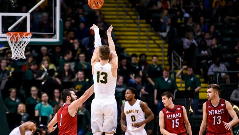 Wright State University’s Grant Benzinger puts up a jumper defended by Miami University’s Zach McCormick during their 89-87 win over Miami Tuesday, Nov. 15 at Wright State University’s Nutter Center in Fairborn. NICK GRAHAM/STAFF
