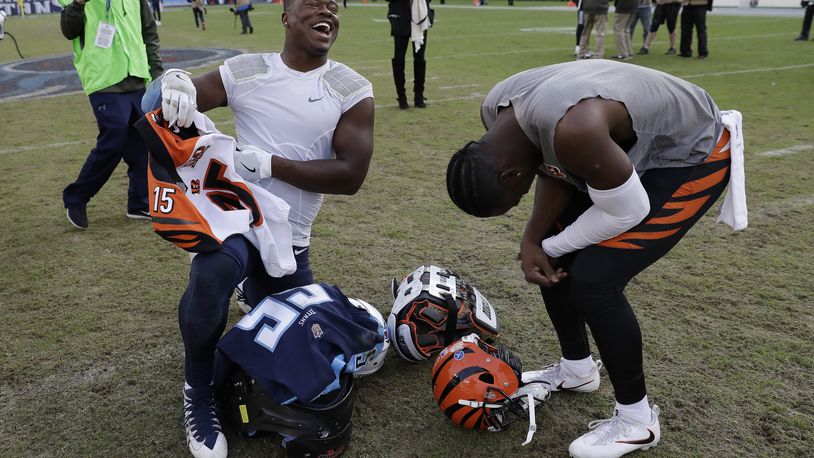 Tennessee Titans linebacker Jayon Brown, left, trades jerseys with Cincinnati Bengals wide receiver John Ross, right, after an NFL football game Sunday, Nov. 12, 2017, in Nashville, Tenn. The Titans won 24-20.(AP Photo/James Kenney)