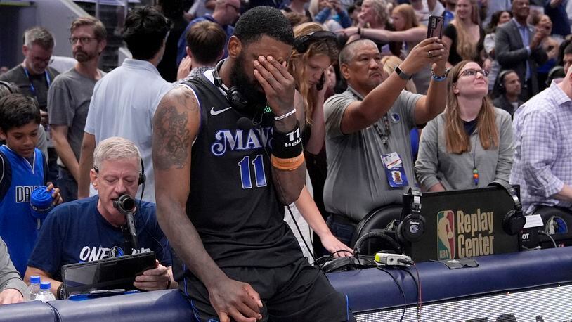 Dallas Mavericks' Kyrie Irving (11) pauses as he waits to do a broadcast interview following the teams win in Game 6 of an NBA basketball second-round playoff series against the Oklahoma City Thunder Saturday, May 18, 2024, in Dallas. (AP Photo/Tony Gutierrez)