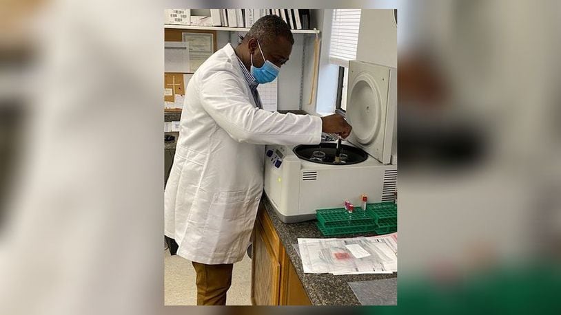 Kofi Amoah places a blood sample in a centrifuge to check for antibodies. Amoah is also doing work to start a mobile vaccine clinic. CONTRIBUTED