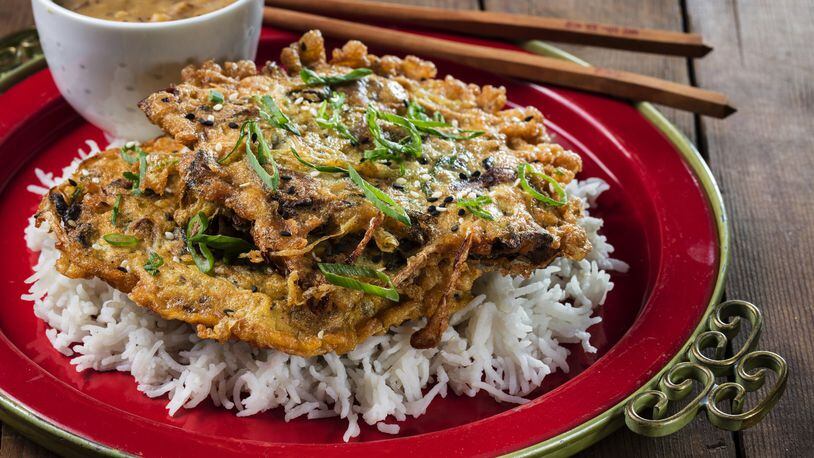 Egg foo young with mushrooms and bean sprouts, served over rice with a mushroom gravy; styling by Mark Graham. (Zbigniew Bzdak/Chicago Tribune/TNS)