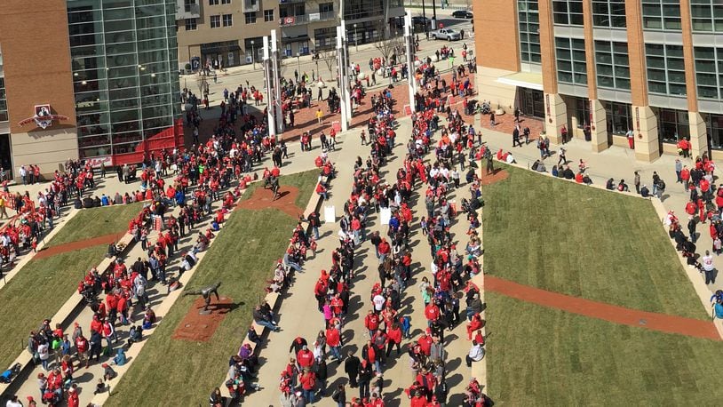 Fans wait in line to get into Great American Ball Park before a game between the Reds and Nationals on Saturday, March 31, 2018, in Cincinnati. David Jablonski/Staff