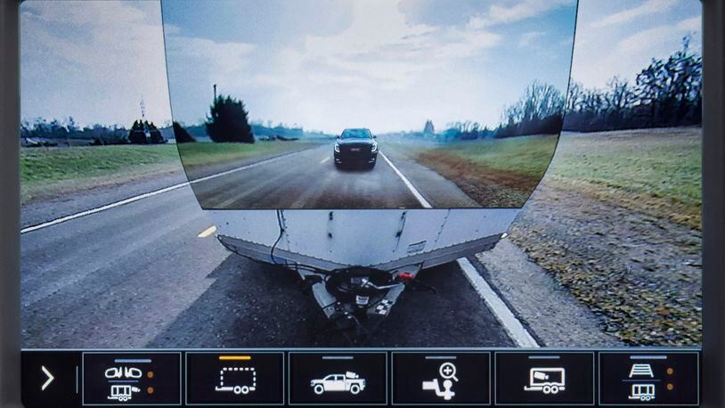 This image provided by General Motors, shows the display of a 2020 GMC Sierra HD feature called Transparent Trailer, one of the few pickup trucks that provides an image of the road behind a trailer. This optional feature uses augmented reality to project an image of the road on the front of a trailer, giving the illusion of a transparent trailer. (General Motors via AP)