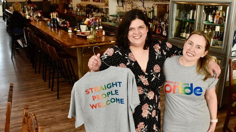 Melissa Kutzera, left, and Monica Nenni, owners of West Central Wine show off shirts being sold to raise money for the upcoming pride parade Tuesday, April 16 in Middletown. NICK GRAHAM/STAFF