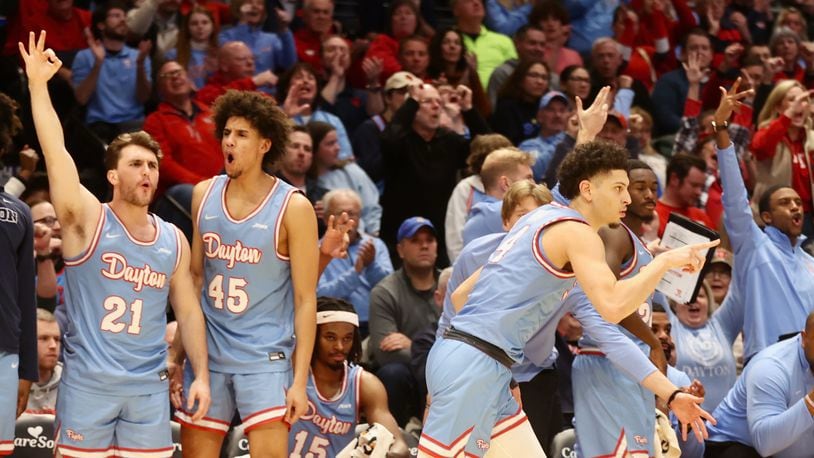 Dayton players on the bench react after a 3-pointer by Koby Brea against Saint Louis on Tuesday, Jan. 16, 2024, at UD Arena. David Jablonski/Staff