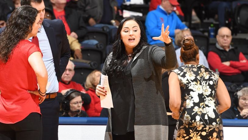 Dayton assistant coach Calamity McEntire talks to head coach Shauna Green and assistant Ryan Gensler during Friday afternoon’s game vs. Buffalo at UD Arena. Erik Schelkun/CONTRIBUTED