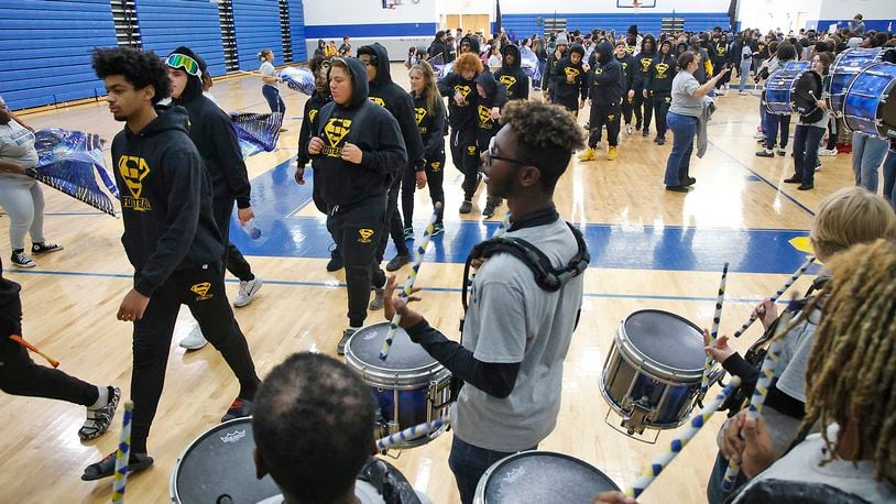 The Springfield High School Marching Band plays and the studens and staff cheer as the Wildcats walk through the school's halls and gymnasium and are sent off Thursday, Nov. 30, 2023 for the Division I State Championship in Canton. BILL LACKEY/STAFF