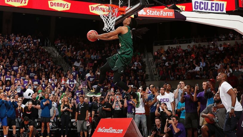 Wright State’s Steven Davis throws down his first attempt, which featured him approaching the rim from behind the baseline after taking a pass off the backboard from assistant coach Sharif Chambliss (lower right), during the NCAA Slam Dunk Contest on Thursday night in Phoenix. Steve Woltmann/Contributed photo