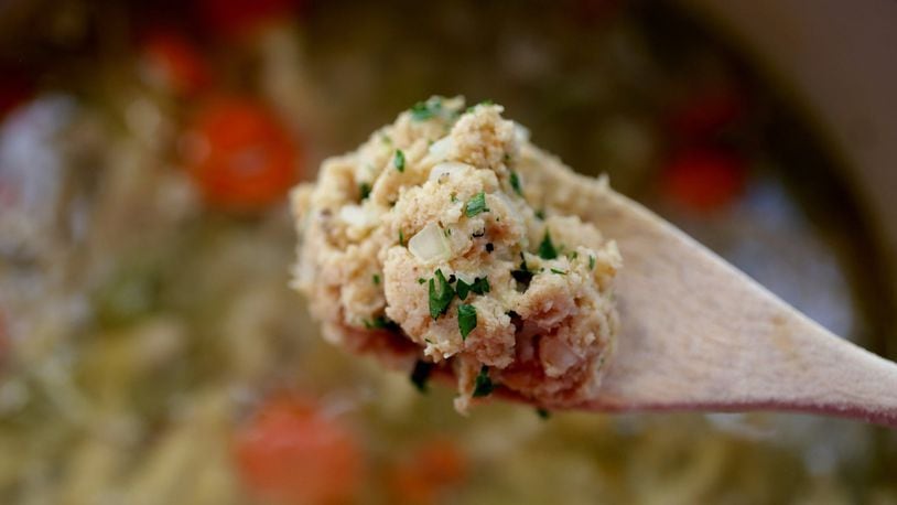 A spoonful of dumpling dough poised above the pot of chicken and dumplings. (Hillary Levin/St. Louis Post-Dispatch/TNS)