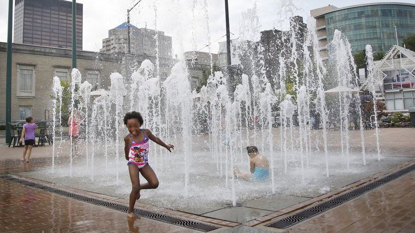 Sylah Hughley, 5, dances alon the edge of the cool fountains at RiverScape on Monday as the temperatures climbed into the upper 80’s. Hughley enjoyed the trip with her mother Chaquinta Hughley. TY GREENLEES / STAFF