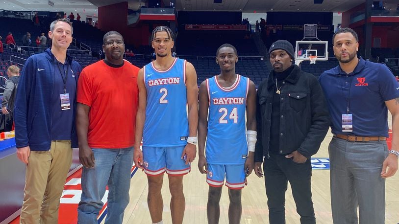 Members of the 2002-03 Dayton Flyers pose for photos with current Flyers on Friday, Nov. 11, 2022, at UD Arena. Pictured from left to right are: Keith Waleskowski; Nate Green; Toumani Camara; Kobe Elvis; Ramod Marshall; and Brooks Hall. Contributed photo
