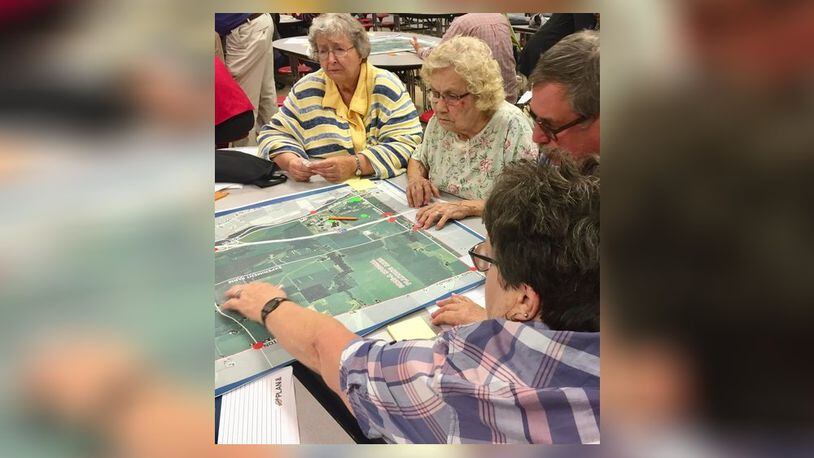Participants in a community meeting on the study of the County Road 25A corridor between Troy and Piqua review a map of the study area. They were asked to identify the good and not so good features of the area. CONTRIBUTED PHOTO