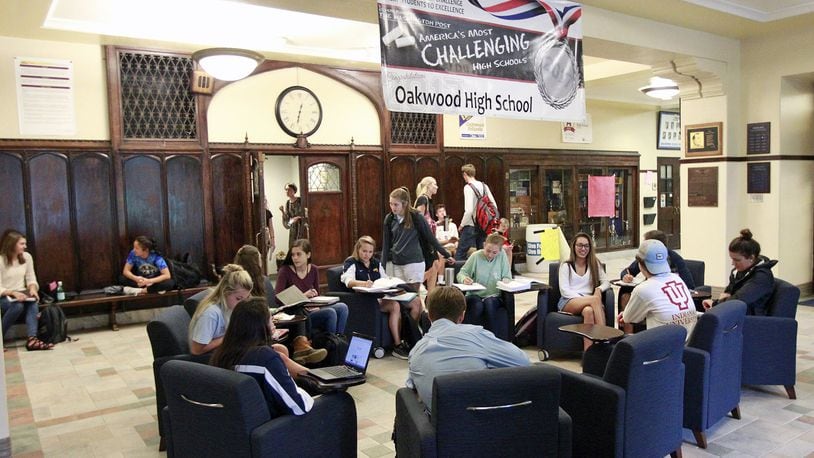 Oakwood High School students study in the entryway of the building during their lunch period. Oakwood ranked first among Ohio high schools in both Performance Index and the Prepared for Success measurement, according to Ohio school report card data. TY GREENLEES/STAFF