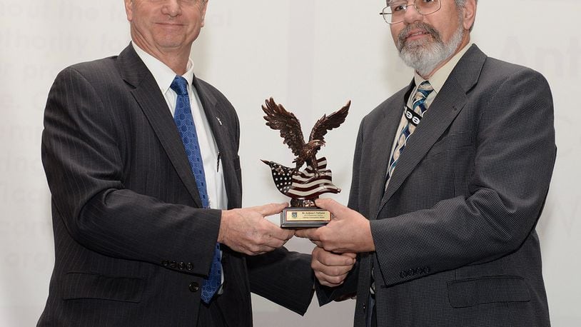 Dr. Ken Barker, Air Force senior leader for Systems Engineering and acting director of Engineering and Technical Management/Services, Air Force Life Cycle Management Center, presents the 2017 Air Force Life Cycle Management Center Engineering Frederick T. Rall Jr. Lifetime Achievement Award to Anthony J. DalSasso, chief engineer, Simulators Program Office, Agile Combat Support Directorate, during a ceremony at Wright-Patterson Air Force Base Feb. 15. DalSasso performed in various engineering roles throughout AFLCMC and its predecessor engineering section chief, and ultimately the chief engineer of the Simulators Program Office. (U.S. Air Force photo/Michelle Gigante)