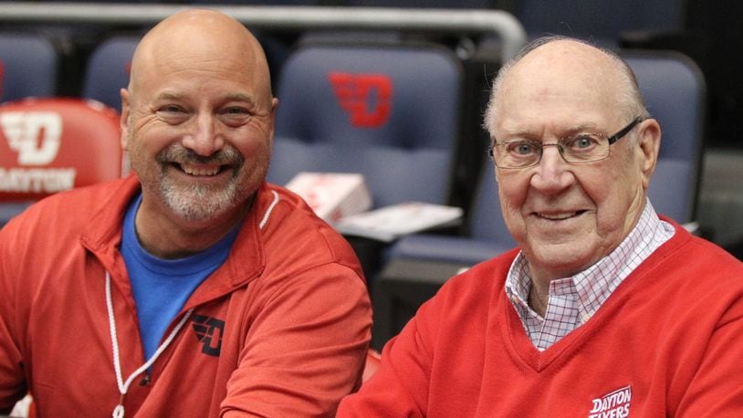 WHIO’S Larry Hansgen and Bucky Bockhorn pose for a photo before Dayton’s game against North Florida on Wednesday, Nov. 7, 2018, at UD Arena. David Jablonski/Staff