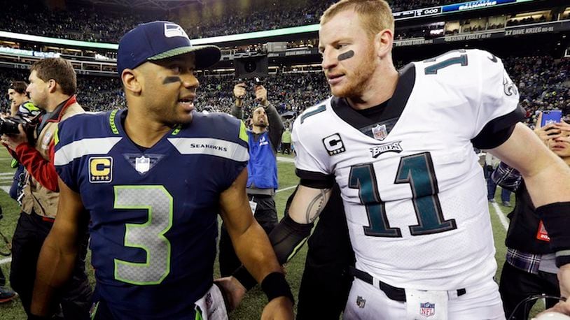 Seattle Seahawks quarterback Russell Wilson (3) talks with Philadelphia Eagles quarterback Carson Wentz after an NFL football game, Sunday, Dec. 3, 2017, in Seattle. The Seahawks won 24-10. (AP Photo/Ted S. Warren)