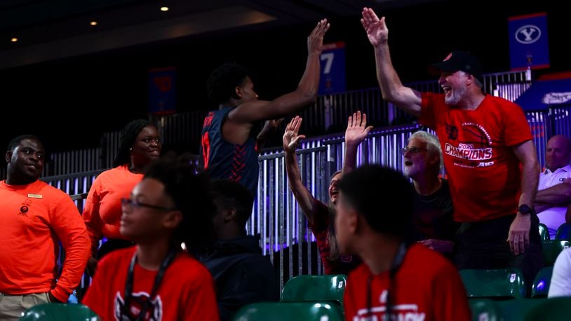 Dayton's Malachi Smith slaps hands with fans in the stands after scoring against N.C. State on Thursday, Nov. 24, 2022, in the consolation round of the Battle 4 Atlantis at Imperial Arena at the Paradise Island Resort in Nassau, Bahamas. David Jablonski/Staff