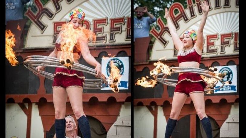 Casey Martin of the performing duo the KamiKaze FireFlies broke her own world Guinness World Record  for the most flaming hula hoops on the body at the Ohio Renaissance Festival near Waynesville Sunday, Sept. 29.