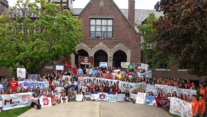 In an annual tradition, the Oakwood High School Class of 2016 gathers in front of the school displaying banners for the colleges they will attend. CONTRIBUTED