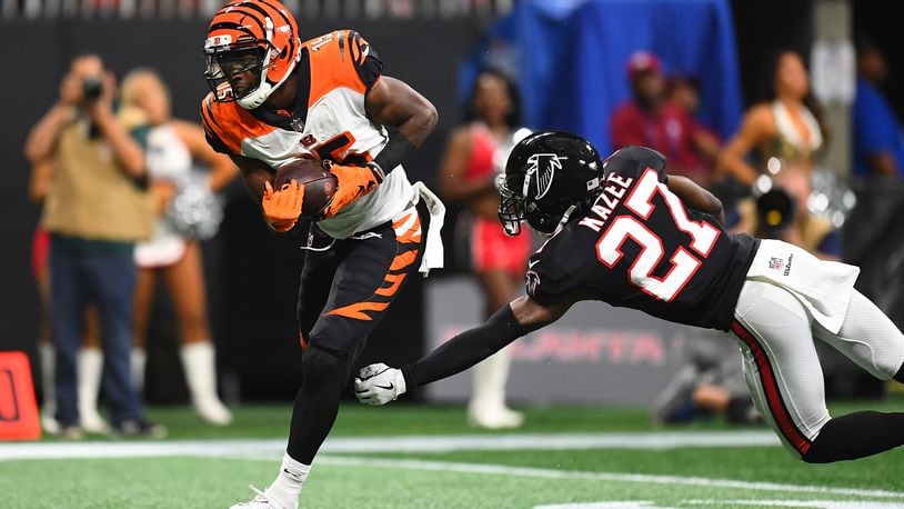 John Ross #15 of the Cincinnati Bengals breaks a tackle by Damontae Kazee #27 of the Atlanta Falcons en route to a touchdown during the second quarter at Mercedes-Benz Stadium on September 30, 2018 in Atlanta, Georgia. (Photo by Scott Cunningham/Getty Images)