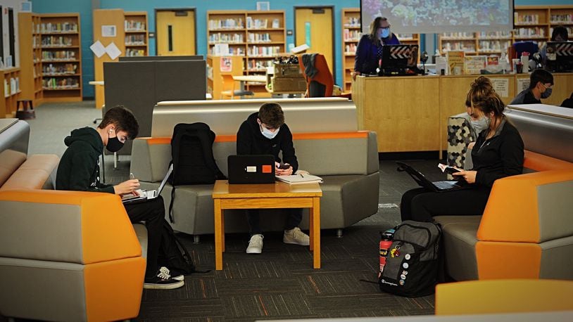 Beavercreek High School students work in the library Thursday, Oct. 8, 2020. Many students' school years have been interrupted by 14-day quarantines when they've been closely exposed to someone with COVID-19.