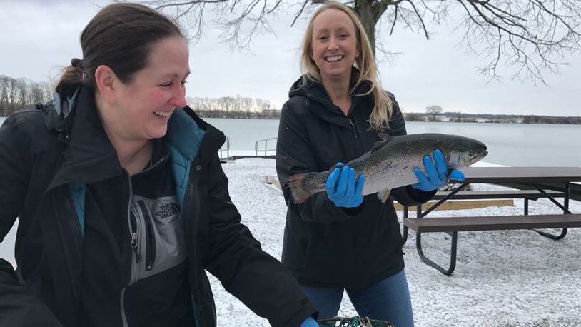 Danielle Trevino (holding fish) and Megan Shade with Base Natural Resources stock Bass Lake at Wright-Patterson Air Force Base with trout on March 14. (Courtesy photo)