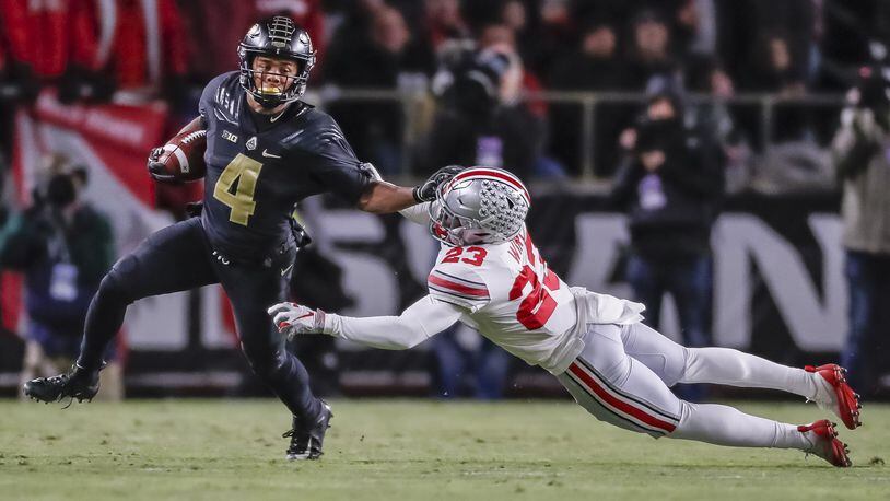 Rondale Moore (left) of the Purdue Boilermakers runs the ball and tries to fight off Jahsen Wint of the Ohio State Buckeyes at Ross-Ade Stadium this past Saturday at West Lafayette, Ind. (Photo by Michael Hickey/Getty Images)