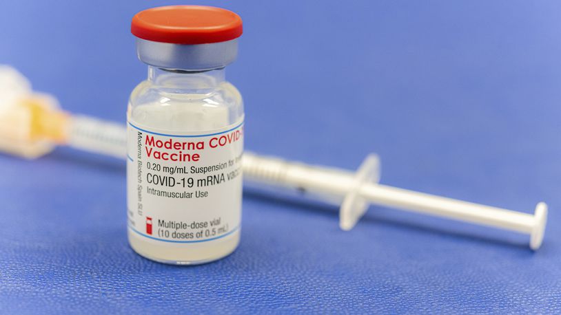 An ampoule Moderna vaccine against the COVID-19 disease, stand on the table at the Diakonie Hospital "DIAKO" vaccination ward in Bremen, Germany, Friday, Jan. 15, 2021. Besides the Pfizer/BioNTech vaccine, Moderna is the second corona vaccine approved in the European Union. (Mohssen Assanimoghaddam/dpa via AP)