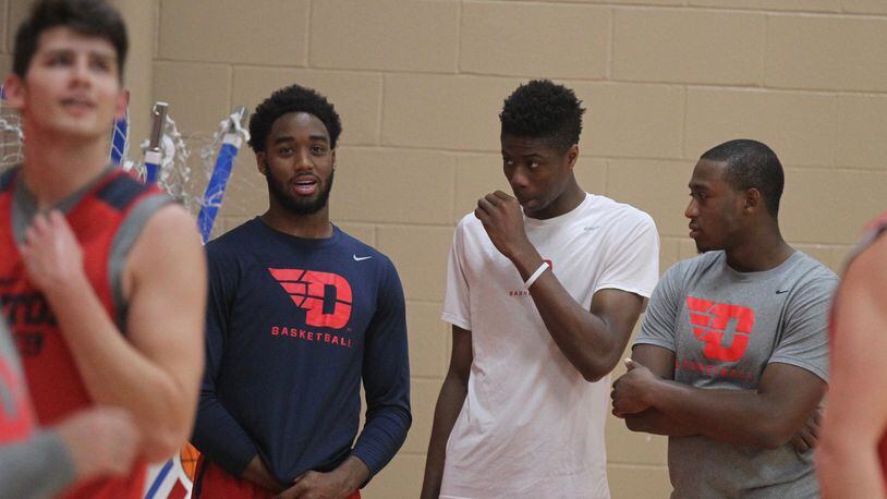 Josh Cunningham, left, talks to Kostas Antetokounmpo and Kendall Pollard during practice on Monday. Cunningham did not practice Monday because of an illness but was expected to practice Tuesday. David Jablonski/Staff