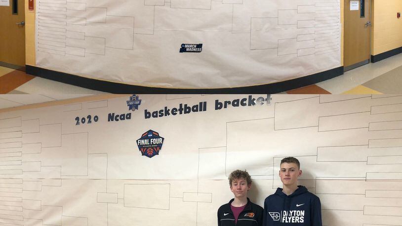 Liam Gluck, left, and Lance Caswell, right, pose with the NCAA tournament bracket they helped create at Jacob Coy Middle School. Submitted photo