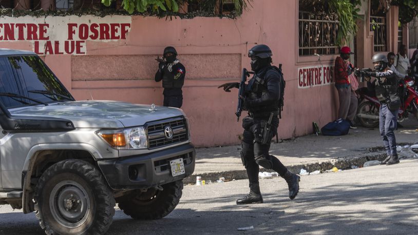 Police stop at a car to inspect in Port-au-Prince, Haiti, Monday, April 22, 2024. (AP Photo/Ramon Espinosa)