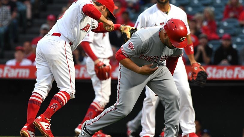 ANAHEIM, CA - JUNE 25: Eugenio Suarez #7 of the Cincinnati Reds is tagged out in a run down play by David Fletcher #6 of the Los Angeles in the first inning at Angel Stadium of Anaheim on June 25, 2019 in Anaheim, California. (Photo by Jayne Kamin-Oncea/Getty Images)