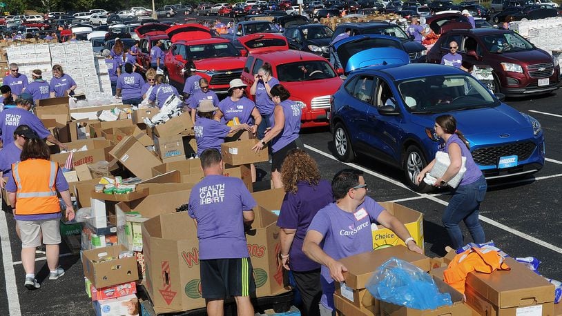The Dayton Foodbank, Inc. along with nearly 200 volunteers from CareSource served over 1,000 families at the University of Dayton Arena Mass food distribution Tuesday Aug. 23, 2022. MARSHALL GORBY\STAFF