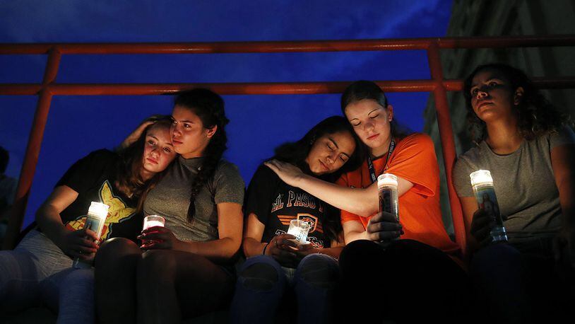 From left, Melody Stout, Hannah Payan, Aaliyah Alba, Sherie Gramlich and Laura Barrios comfort each other during a vigil for victims of the shooting Saturday, Aug. 3, 2019, in El Paso, Texas.