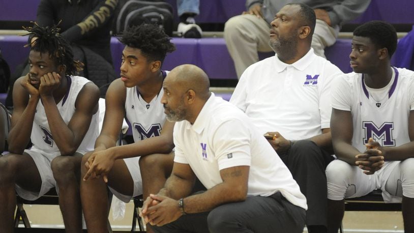 New Beavercreek boys basketball head coach Steve Pittman (second from right) was an assistant to Darnell Hoskins at Middletown last season. MARC PENDLETON / STAFF