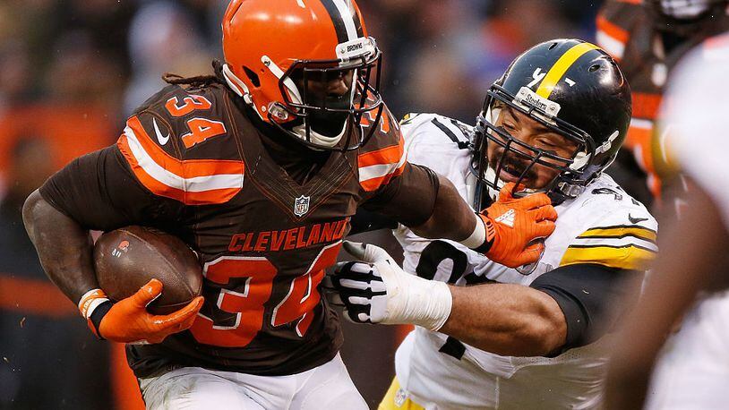 CLEVELAND, OH - JANUARY 3: Isaiah Crowell #34 of the Cleveland Browns stiff arms Cameron Heyward #97 of the Pittsburgh Steelers during the third quarter at FirstEnergy Stadium on January 3, 2016 in Cleveland, Ohio. (Photo by Gregory Shamus/Getty Images)