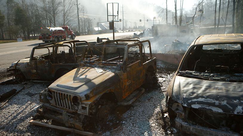 The remains of a Jeep rental business smolders after a wildfire November 29, 2016 in Gatlinburg, Tennessee. Over 100 houses and businesses were damaged or destroyed after drought conditions helped the fire spread through the foothills of the Great Smoky Mountains. (Photo by Brian Blanco/Getty Images)