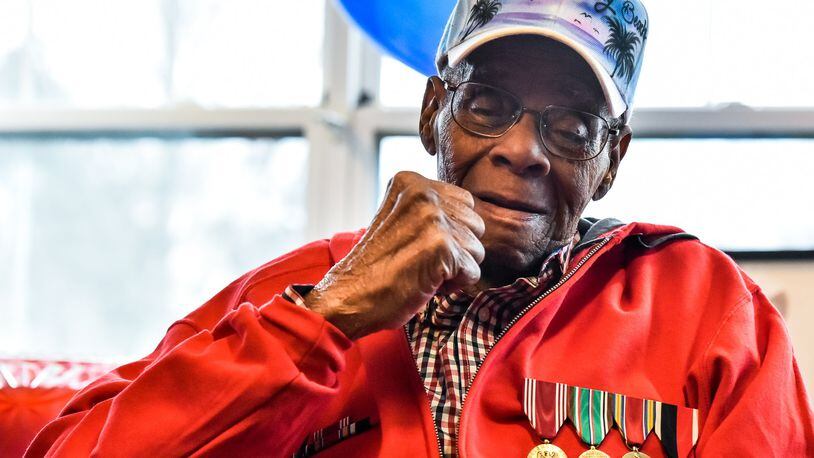 World War II veteran William “Jimmy” Phillips gives a fist pump after receiving his long awaited war medals during a ceremony Thursday, Feb. 22 at Woodlands of Middletown Assisted Living facility. Phillips, who turns 92 next month, has waited nearly 70 years since his discharge to receive his medals. He was awarded the Army Good Conduct Medal, Europe-Africa Middle Eastern Campaign Medal, World War II Victory Medal and the Army of Occupation Medal during the ceremony. Jerry Ferris and Randy Howson with the Military Order of the Purple Heart Chapter 31 presented the medals. NICK GRAHAM/STAFF