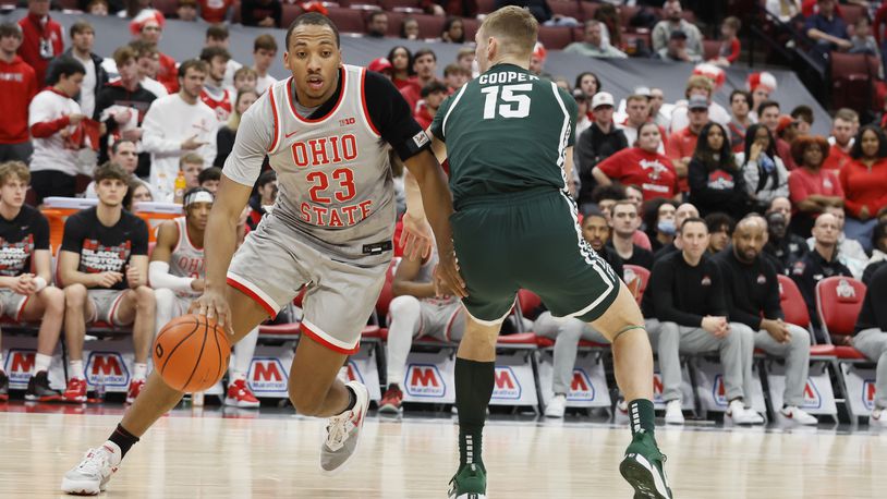 Ohio State's Zed Key, left, drives the baseline past Michigan State's Carson Cooper during the second half of an NCAA college basketball game on Sunday, Feb. 12, 2023, in Columbus, Ohio. (AP Photo/Jay LaPrete)