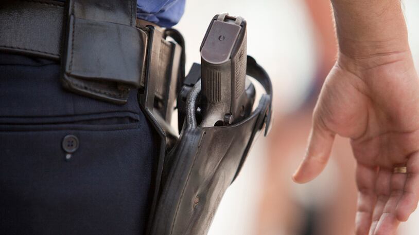 A policeman with his hand close to his gun (stock photo).