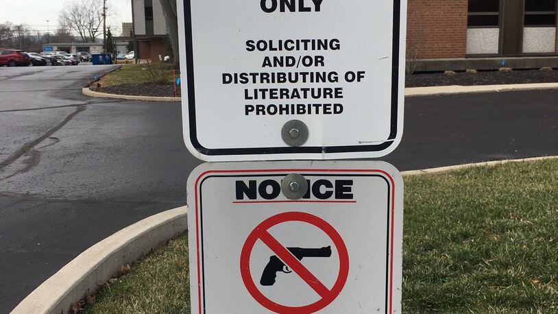 Beginning on March 21 companies will no longer be able to ban people with concealed carry permits from bringing handguns into company parking lots. The guns must remain stored inside a locked car. This sign and two others were removed in February from the parking lot entrance of Premier Health Fidelity Health Care at 3170 Kettering Blvd. LYNN HULSEY/Staff Writer