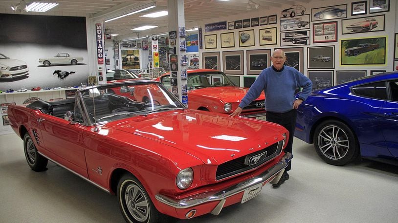Gale Halderman poses with his Mustangs at the Halderman Barn Museum in Tipp City in 2017. Halderman is leaning on a 1965 Mustang convertible, the first Mustang he bought, in 2012. SKIP PETERSON/CONTRIBUTOR