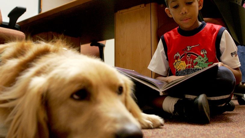 Warren Bess, 8, of Colerain Twp., reads to Hitch, the registered therapy dog of Rebecca Townsend, at the Fairfield Lane Library Thursday, September 10, 2009. CONTRIBUTED BY E.L. HUBBARD