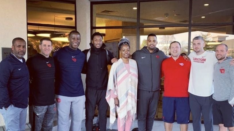 R.J. Blakney and his mom, Dafne’, pose with the Dayton coaching staff during their visit to campus. Submitted photo