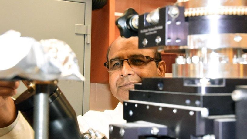 Dr. Ajit Roy, Air Force Research Laboratory’s Computational Nanomaterials of the Materials and Manufacturing Directorate principal engineer and group lead uses a physical vapor deposition system set up for thin film materials deposition on a substrate. (U.S. Air Force photo/David Dixon)