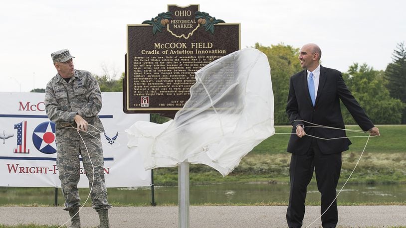 Lt. Gen. Robert D. McMurry, commander, Air Force Life Cycle Management Center, Wright-Patterson Air Force Base, and Matt Joseph, city of Dayton commissioner, unveil the new McCook Field historical marker during the McCook Field Centennial Ceremony in Dayton Oct. 6, celebrating a century of aerospace innovation. In 1917, the U.S. Army Signal Corps Airplane Engineering Department opened new facilities at McCook Field. It played a key role in the early rearing of the nation s aviation industry and earned the name, Cradle of Aviation. (U.S. Air Force photo/Wesley Farnsworth)