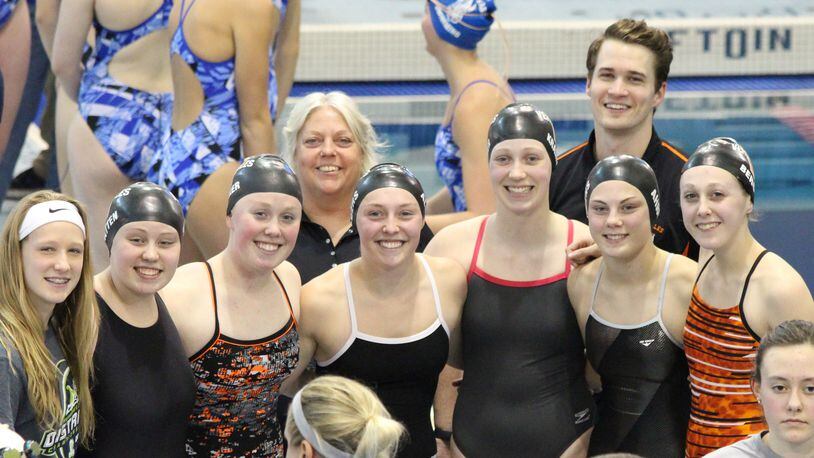 Most of the Versailles girls swim team posted personal bests in the D-II district meet. Members are Coach Penny Cromwell, Payton Berger, Emily Kramer, Heather Albers, Faith Wilker, Courtney Batten, Tori Ahrens, Coach Mark Travis. CONTRIBUTED PHOTO