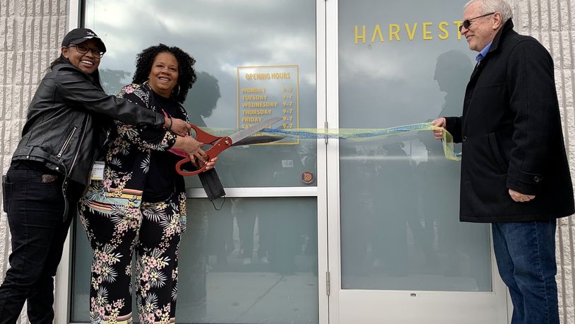 CEO Ariane Kirkpatrick cuts the ribbon of medical marijuana dispensary Harvest of Beavercreek with Beavercreek mayor Bob Stone.