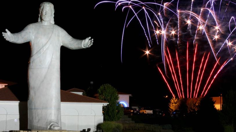 The Lux Mundi statue stands facing I-75 during a fireworks display at the Solid Rock Church Sunday evening, September 30, 2012. Solid Rock Church held a dedication ceremony for the statue that was designed by sculptor Tom Tsuchiya. Contributed photo by Jessica Uttinger